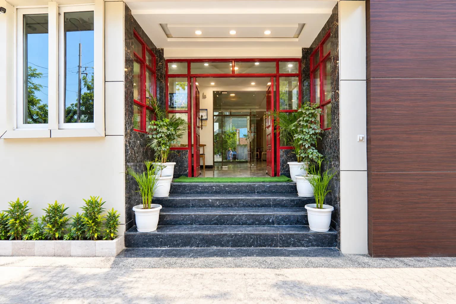 Main entrance steps lined with plants